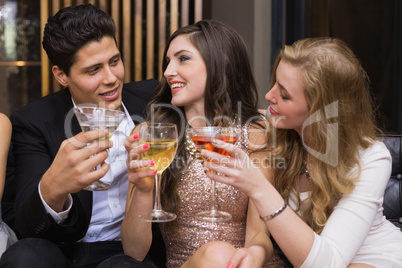 Happy friends having a drink together