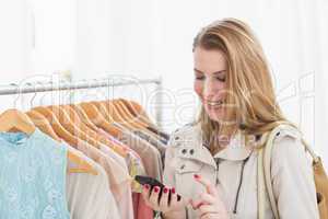 Pretty shopping blonde texting a message