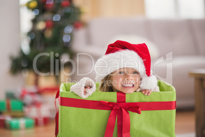 Cute little girl sitting in giant christmas gift