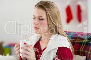 Woman enjoys having a coffee on her couch
