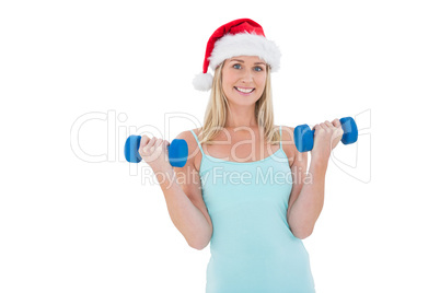 Festive fit blonde holding dumbbells