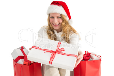 Woman in santa hat offering a gift