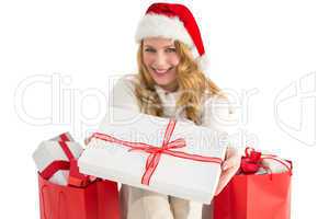 Woman in santa hat offering a gift