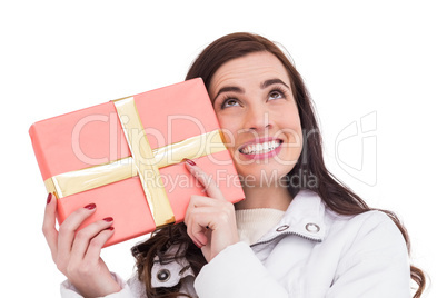 Portrait of a happy brunette holding gift