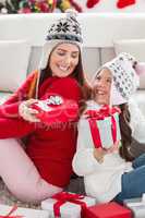 Mother and daughter exchanging gifts at christmas