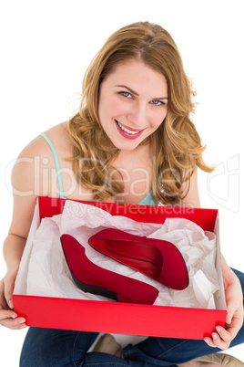 Pretty young woman showing her present