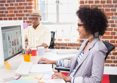 Female photo editor using computer in office