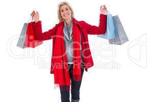 Blonde in winter clothes holding shopping bags