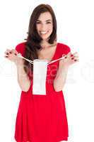 Stylish brunette in red dress holding shopping bag