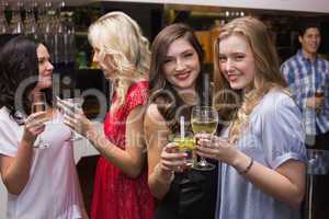 Pretty friends having a drink together