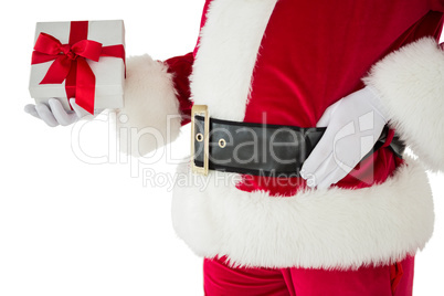 Mid section of santa holding gift