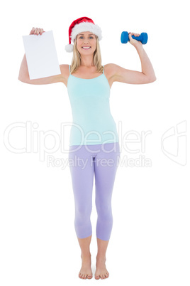 Festive fit blonde holding page and dumbbell