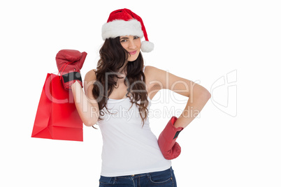 Beauty brunette in boxing gloves with shopping bag