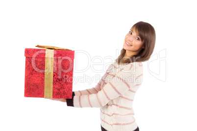 Young woman holding a gift while smiling at camera