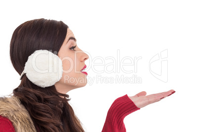 Brunette in winter clothes with hand out Brunette in winter clothes with hand out