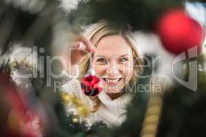 Festive blonde hanging bauble on christmas tree