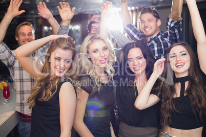 Stylish friends dancing and smiling