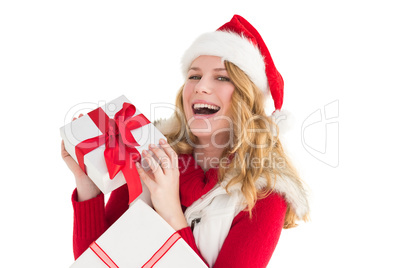 Happy woman in santa hat holding a gift