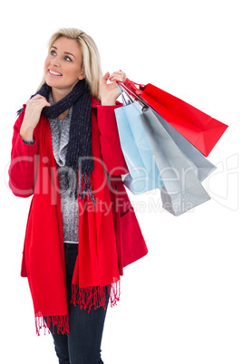 Blonde in winter clothes holding shopping bags