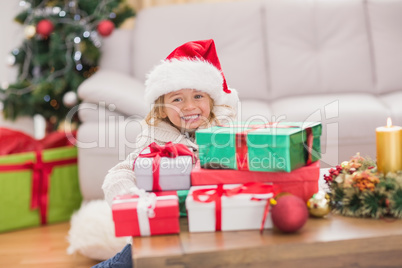 Cute little girl surrounded by christmas gifts