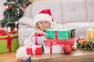 Cute little girl surrounded by christmas gifts