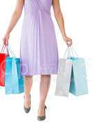 Mid section of woman holding shopping bags