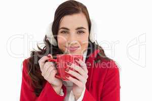 Woman in winter clothes enjoying a hot drink