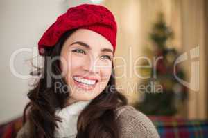 Smiling brunette on the couch at christmas