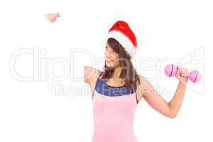 Festive fit brunette holding poster with dumbbell