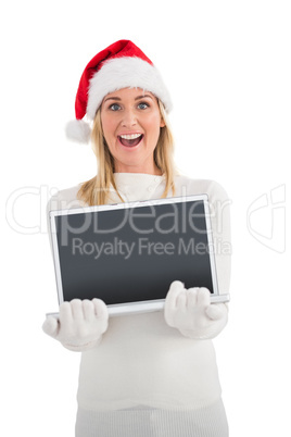 Festive blonde showing a laptop