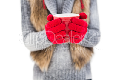 Woman in winter clothes holding a mug