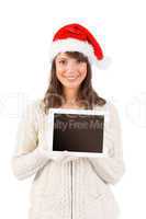 Festive brunette holding a tablet pc