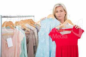 Pretty shopping blonde choosing a dress