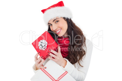 Smiling brunette holding christmas gifts