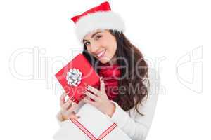 Smiling brunette holding christmas gifts