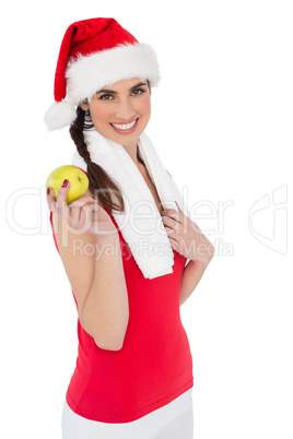 Festive fit brunette holding apple