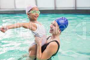 Happy mother and daughter in the swimming pool