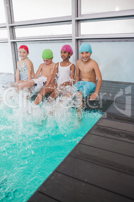 Cute little kids sitting poolside