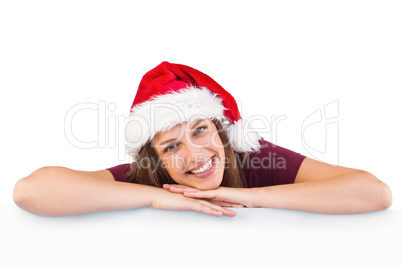 Festive brunette leaning on large poster