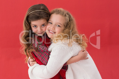 Festive little girls hugging and smiling