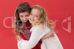 Festive little girls hugging and smiling