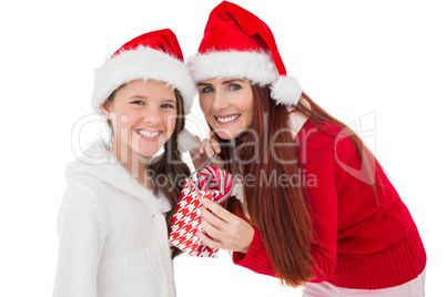 Festive mother giving daughter a gift