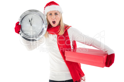 Festive blonde holding a clock and gift