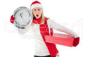 Festive blonde holding a clock and gift