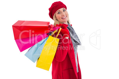 Blonde in winter clothes holding shopping bags