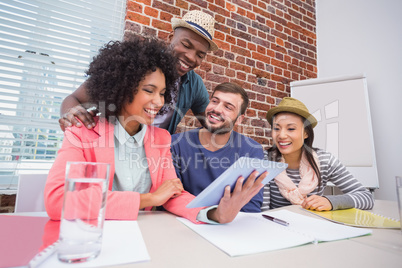 Creative team using digital tablet in meeting Creative team using digital tablet in meeting