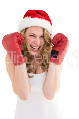 Blonde woman wearing boxing gloves smiling at camera