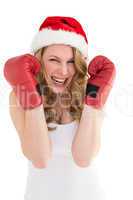 Blonde woman wearing boxing gloves smiling at camera