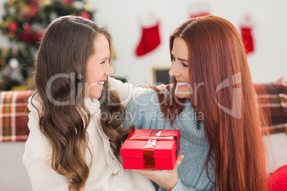 Daughter giving her mother a christmas present