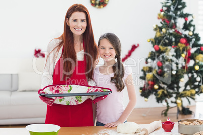 Festive mother and daughter baking together